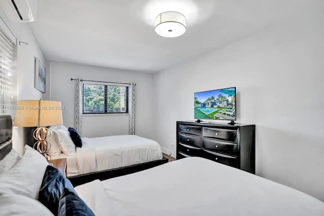 bedroom featuring a wall mounted AC