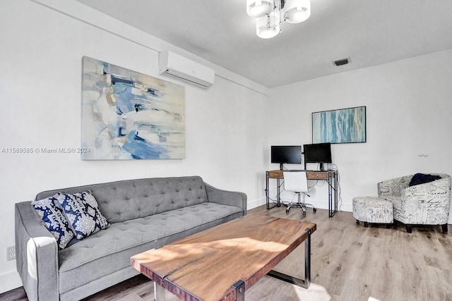 living room featuring a notable chandelier, wood-type flooring, and a wall unit AC