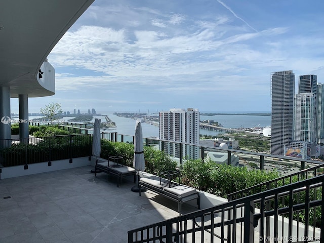 exterior space with a balcony and a water view