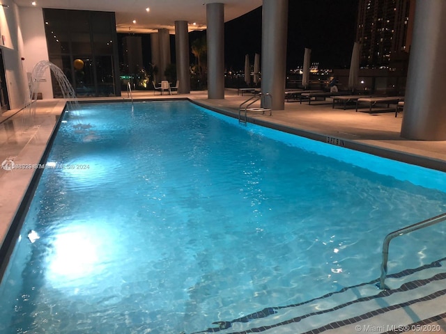 view of swimming pool with a patio and pool water feature