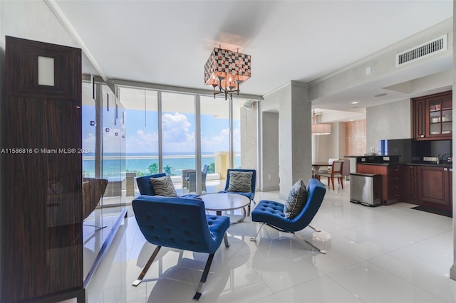 tiled dining room featuring an inviting chandelier, expansive windows, and a water view