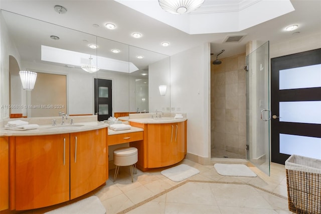 bathroom with a shower with shower door, tile patterned floors, and double vanity