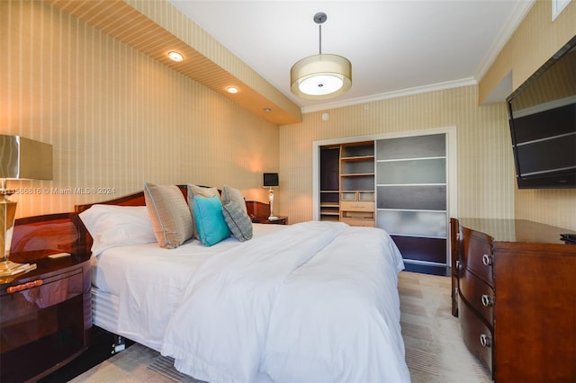 bedroom with crown molding, a closet, and carpet flooring