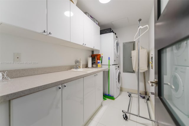 laundry area featuring sink, stacked washer and dryer, and light tile patterned floors