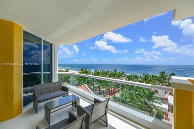 balcony featuring a water view and outdoor lounge area