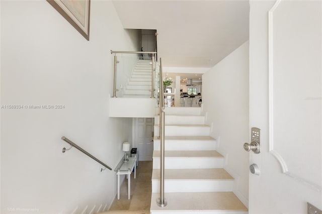 stairway featuring tile patterned floors