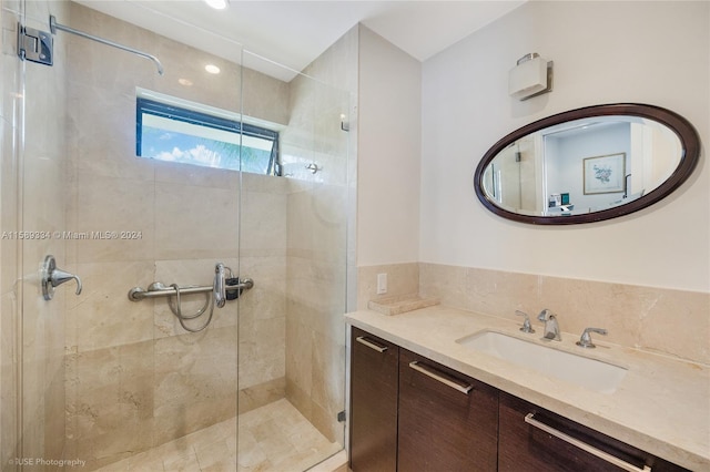 bathroom featuring an enclosed shower and vanity