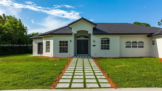 mediterranean / spanish house with a front yard