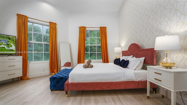 bedroom featuring light hardwood / wood-style floors and multiple windows