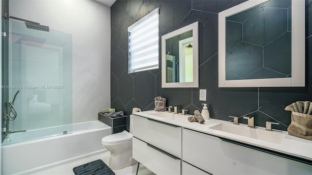 full bathroom featuring vanity, tile walls, and shower / washtub combination