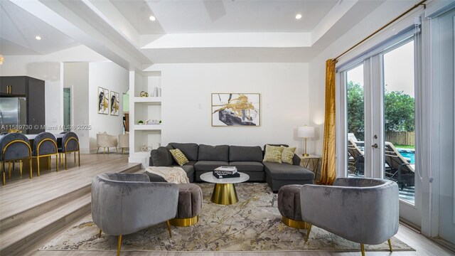 living room featuring light hardwood / wood-style floors and built in features