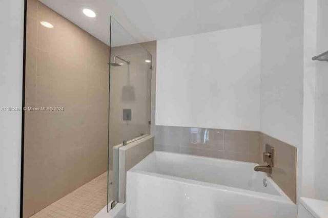 bathroom with shower with separate bathtub