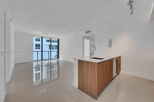 kitchen with sink, light tile flooring, and track lighting