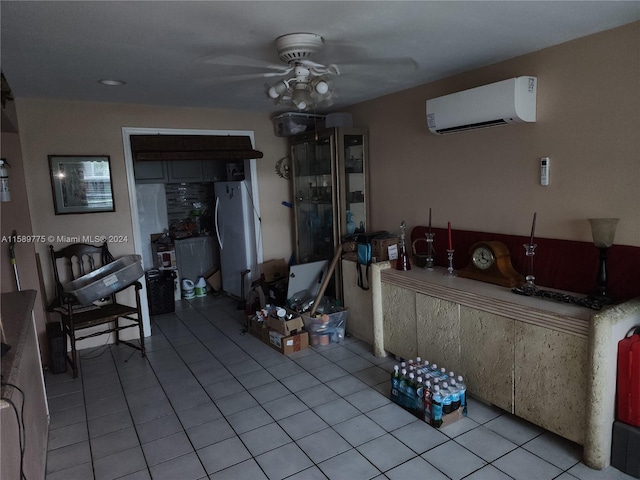 interior space with tile floors, ceiling fan, and a wall mounted air conditioner