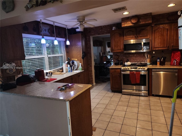 kitchen with stainless steel appliances, hanging light fixtures, ceiling fan, tasteful backsplash, and light tile floors