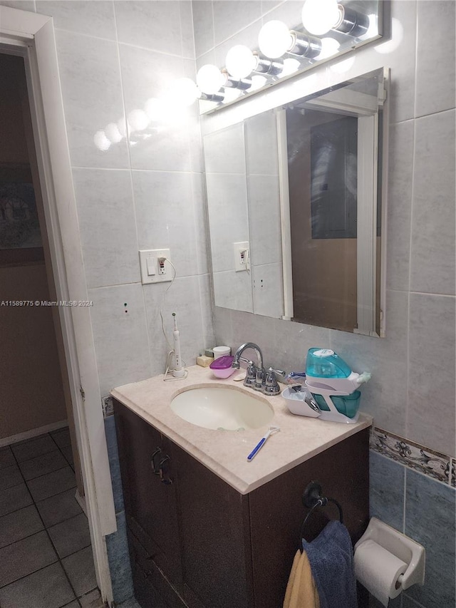 bathroom with tile floors, large vanity, and tile walls