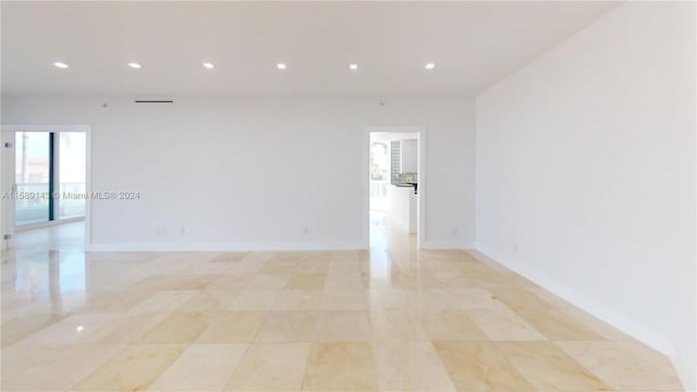 unfurnished room featuring light tile floors