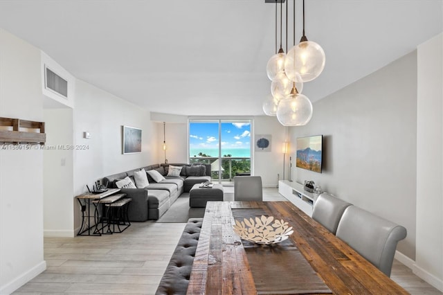 dining space with light hardwood / wood-style floors