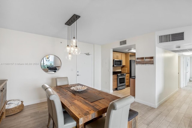 dining space with light hardwood / wood-style floors