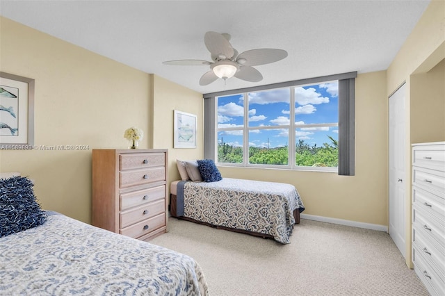 bedroom with ceiling fan and light carpet