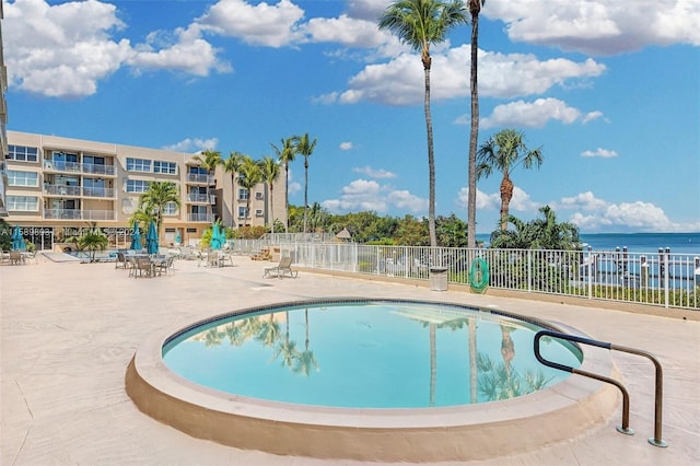 view of swimming pool featuring a water view