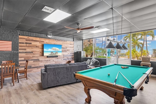 rec room featuring wooden walls, ceiling fan, pool table, and light wood-type flooring