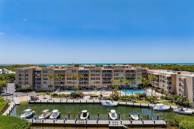 view of property featuring a community pool and a water view