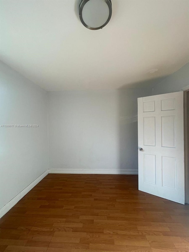 unfurnished bedroom with hardwood / wood-style floors