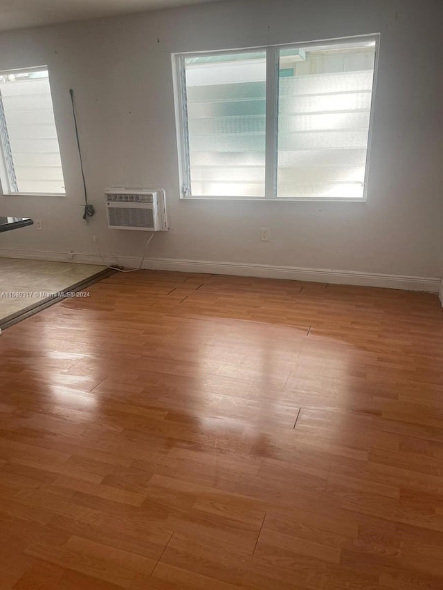 empty room featuring hardwood / wood-style floors and plenty of natural light