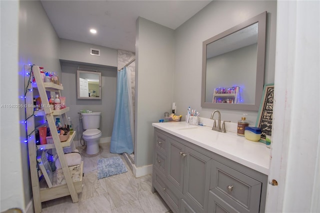 bathroom featuring a shower with shower curtain, vanity, and toilet