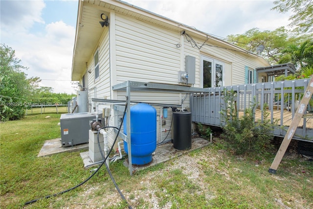 view of property exterior featuring a lawn and a deck