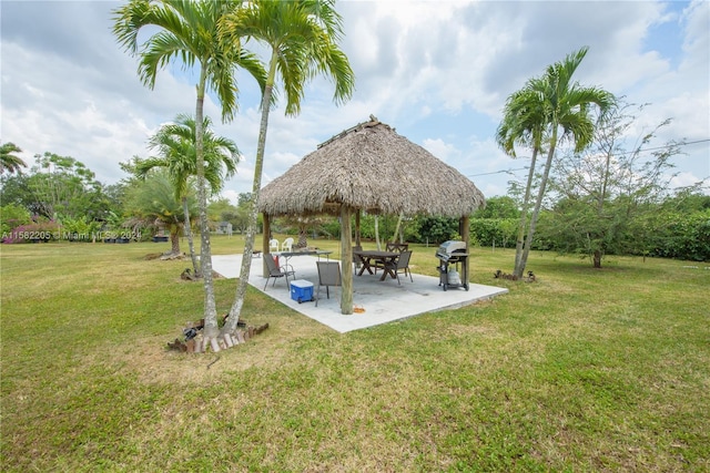 surrounding community featuring a gazebo, a patio, and a lawn