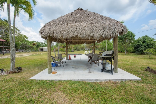 view of home's community with a lawn, a gazebo, and a patio