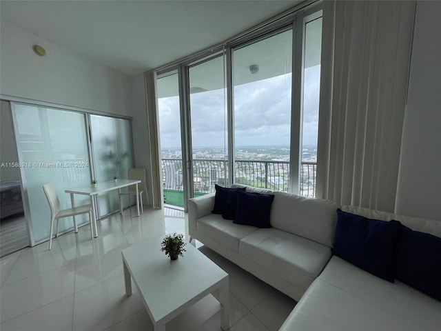 tiled living room with floor to ceiling windows