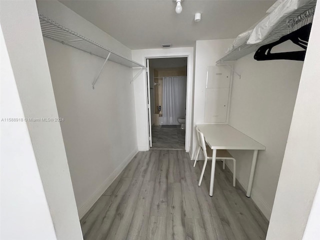 walk in closet featuring light hardwood / wood-style flooring