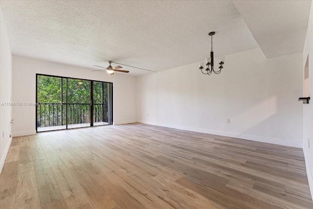 unfurnished room with ceiling fan with notable chandelier, a textured ceiling, and light wood-type flooring