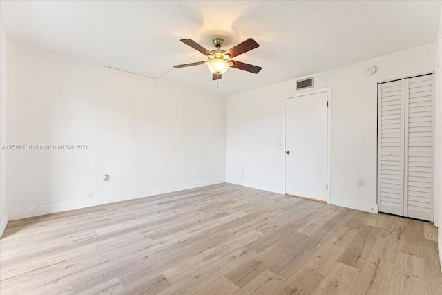 unfurnished bedroom with light hardwood / wood-style floors and ceiling fan