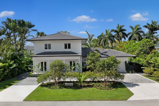 view of front of property featuring a garage and a front yard