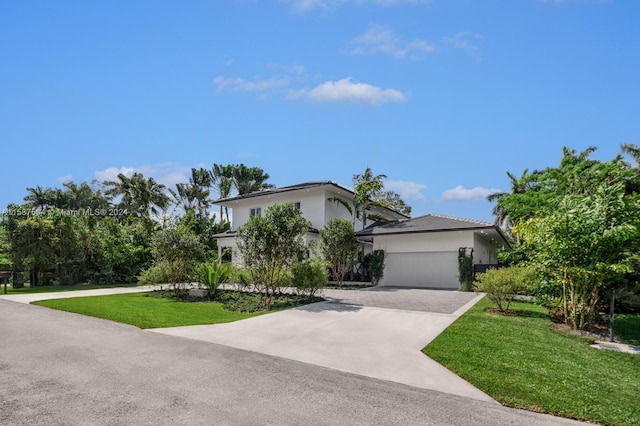 view of front of home with a front yard and a garage