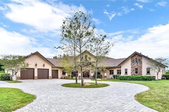 ranch-style house with a garage and a front lawn