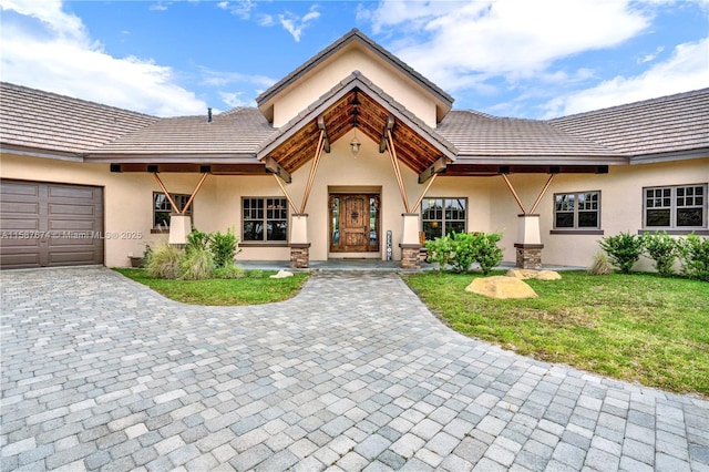 view of front of house with a garage and a front lawn