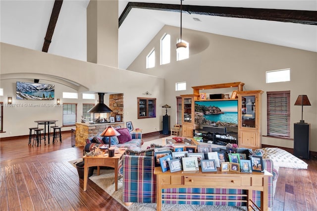 living room featuring high vaulted ceiling, hardwood / wood-style floors, and beam ceiling