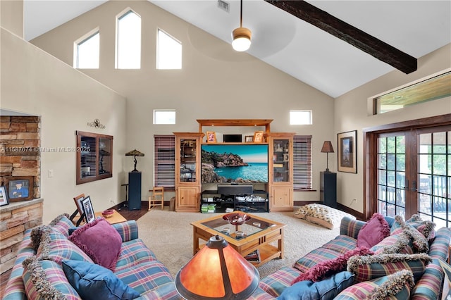 carpeted living room with ceiling fan, french doors, and high vaulted ceiling