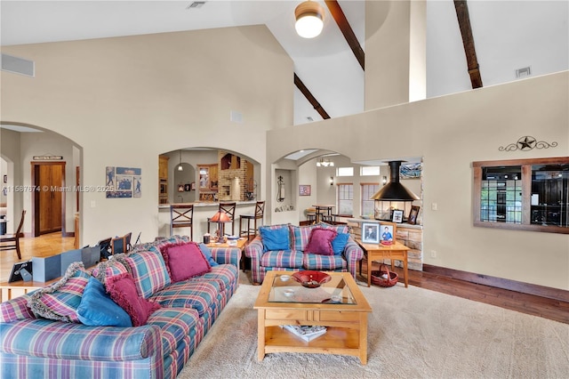 living room featuring high vaulted ceiling