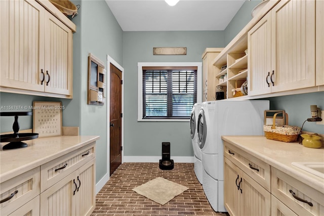 laundry area featuring cabinets and washing machine and clothes dryer