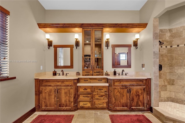 bathroom with vanity and a tile shower