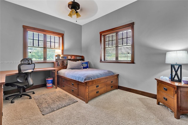 bedroom featuring light carpet and ceiling fan