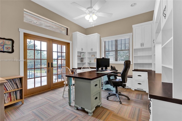 home office featuring ceiling fan, a wealth of natural light, light carpet, and french doors