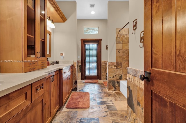 bathroom featuring vanity and a bath