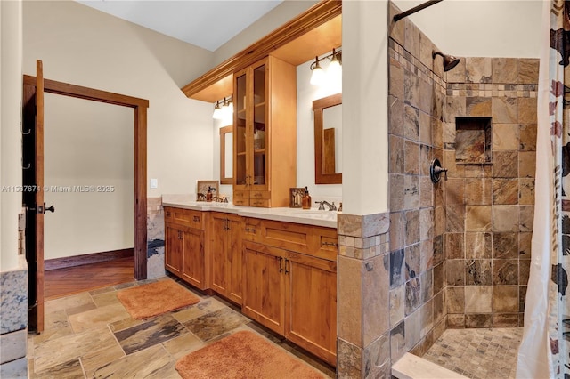 bathroom featuring curtained shower and vanity